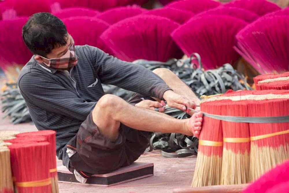 Artisans skillfully crafting incense through traditional methods